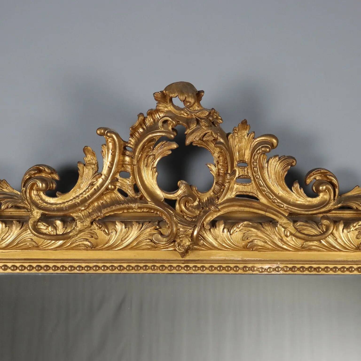 Antique eclectic style mirror in carved and gilded fir, Italy, 19th century.