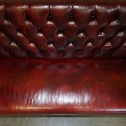 Victorian Chesterfield leather sofa with carved lion heads.