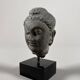 Sculpture of a Buddha head in grey schist from Gandhara, ancient Greece.