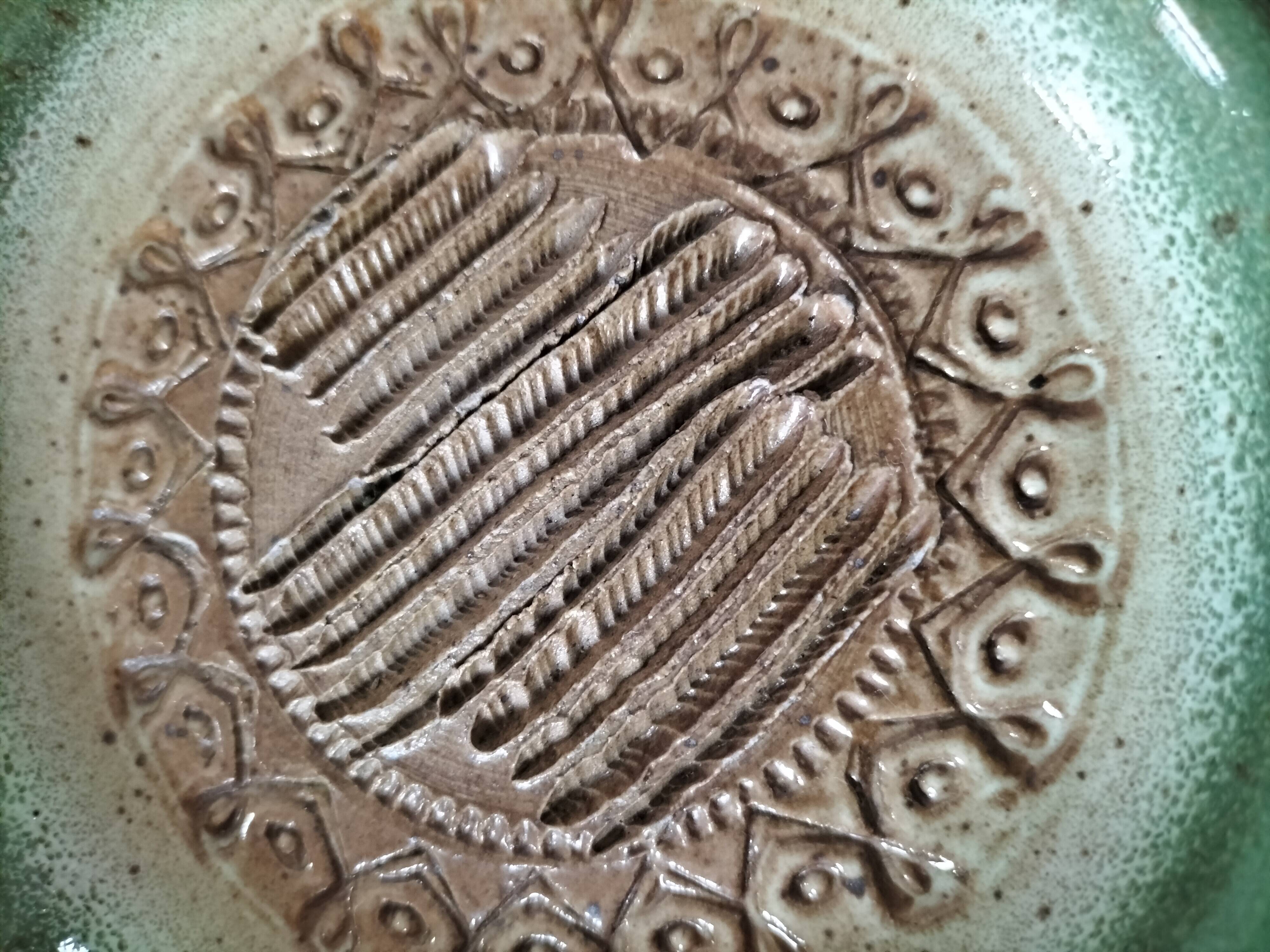 Signed stoneware bowl from Puisaye, relief decoration.