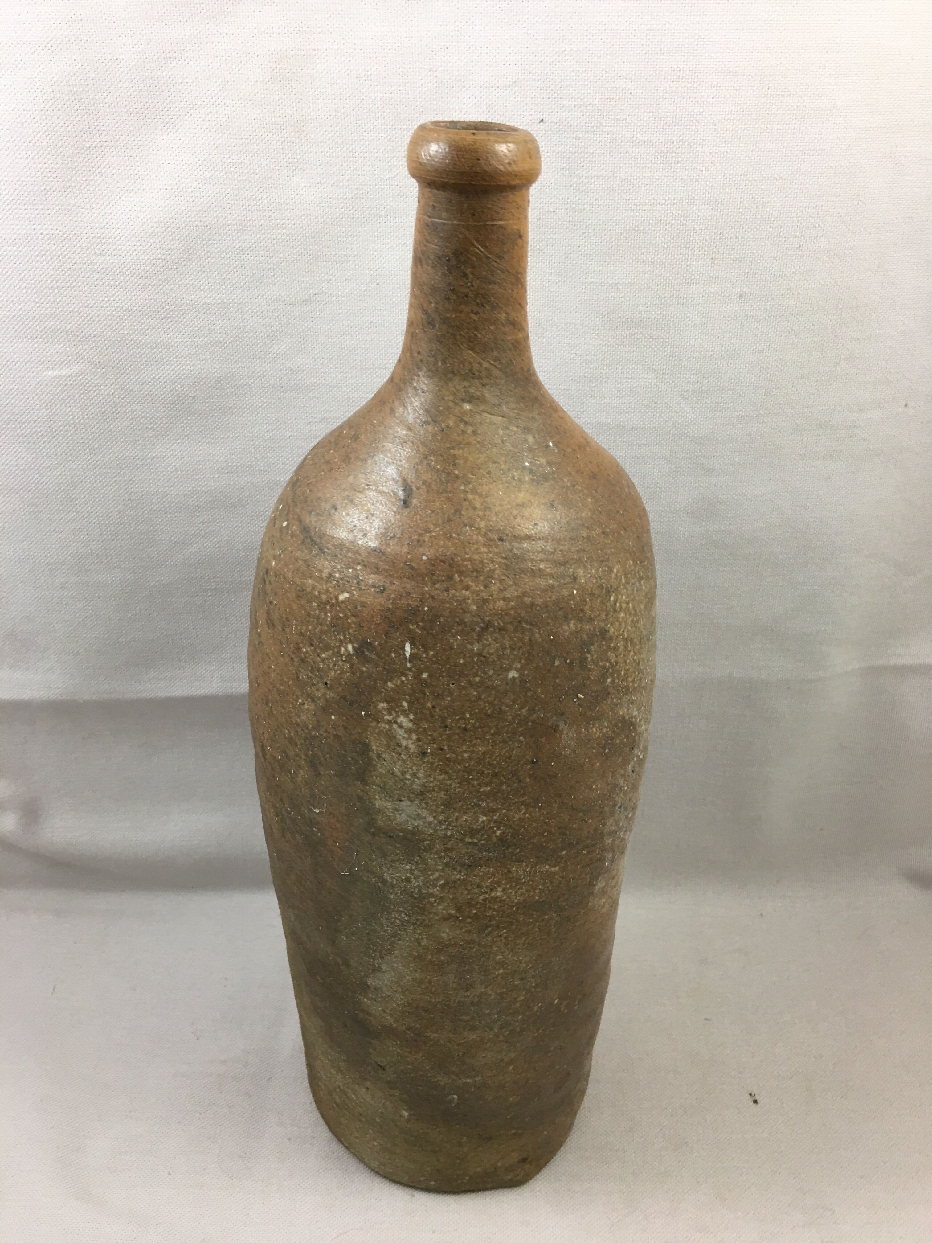 Old bottle in varnished sandstone glazed vintage
