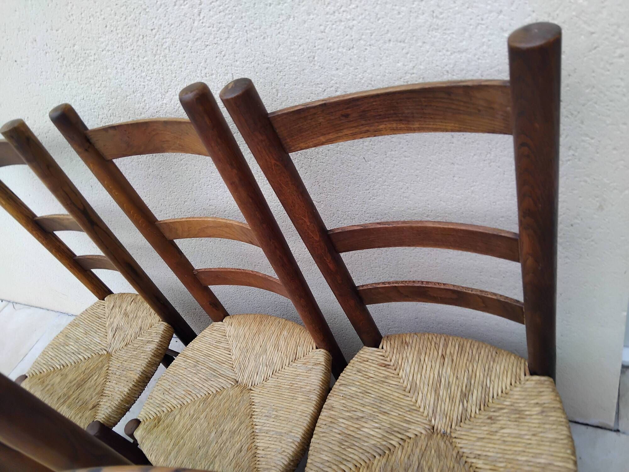 8 vintage straw chairs in the style of Charlotte Perriand.