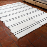 Simple carpet in ecru recycled cotton with black stripes of Berber type