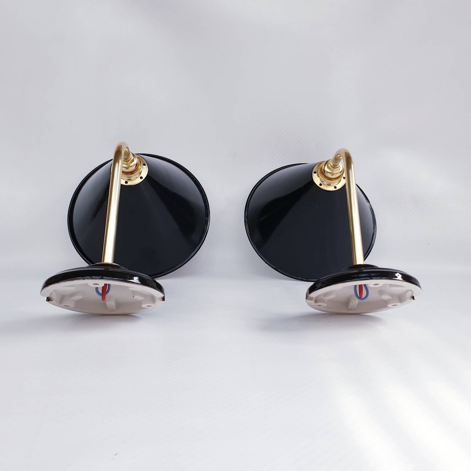 Pair of antique black enamelled sheet metal wall lights