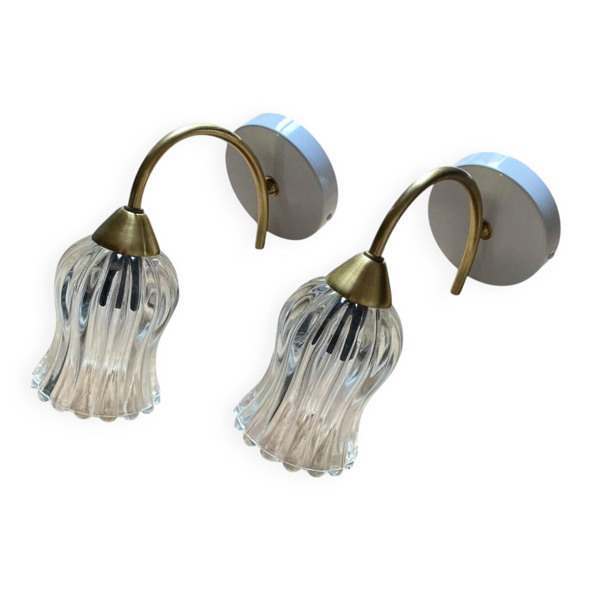 Pair of wall sconces in brass with transparent tulip glass shade.