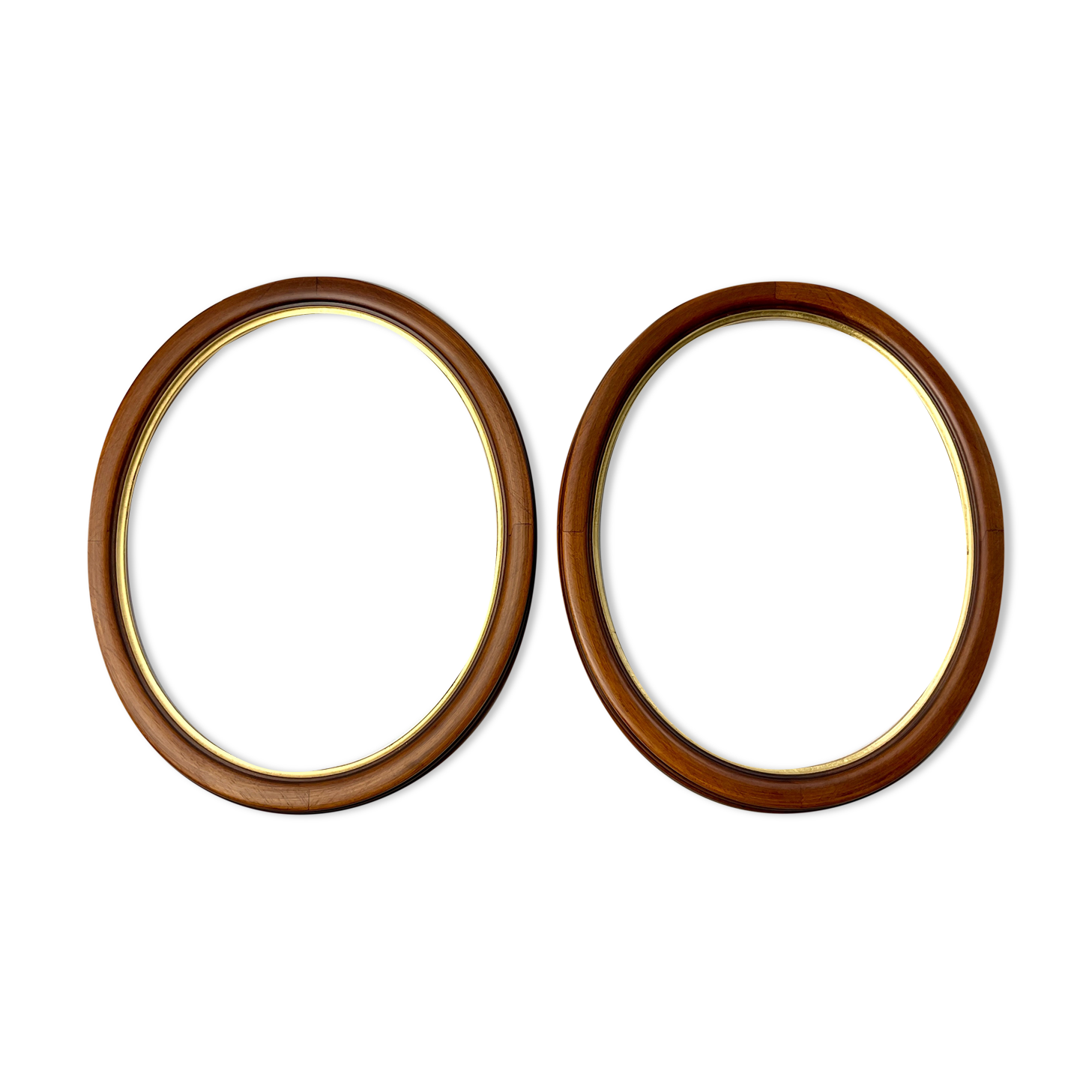 Pair of oval wooden frames with gilding