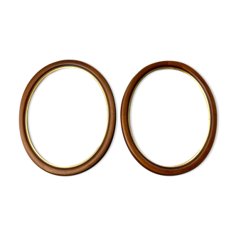 Pair of oval wooden frames with gilding