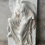 Ancient plaster bas-relief of Nike fastening her sandal.