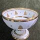 Empire-style footed cup in white porcelain, richly decorated with fine gold.