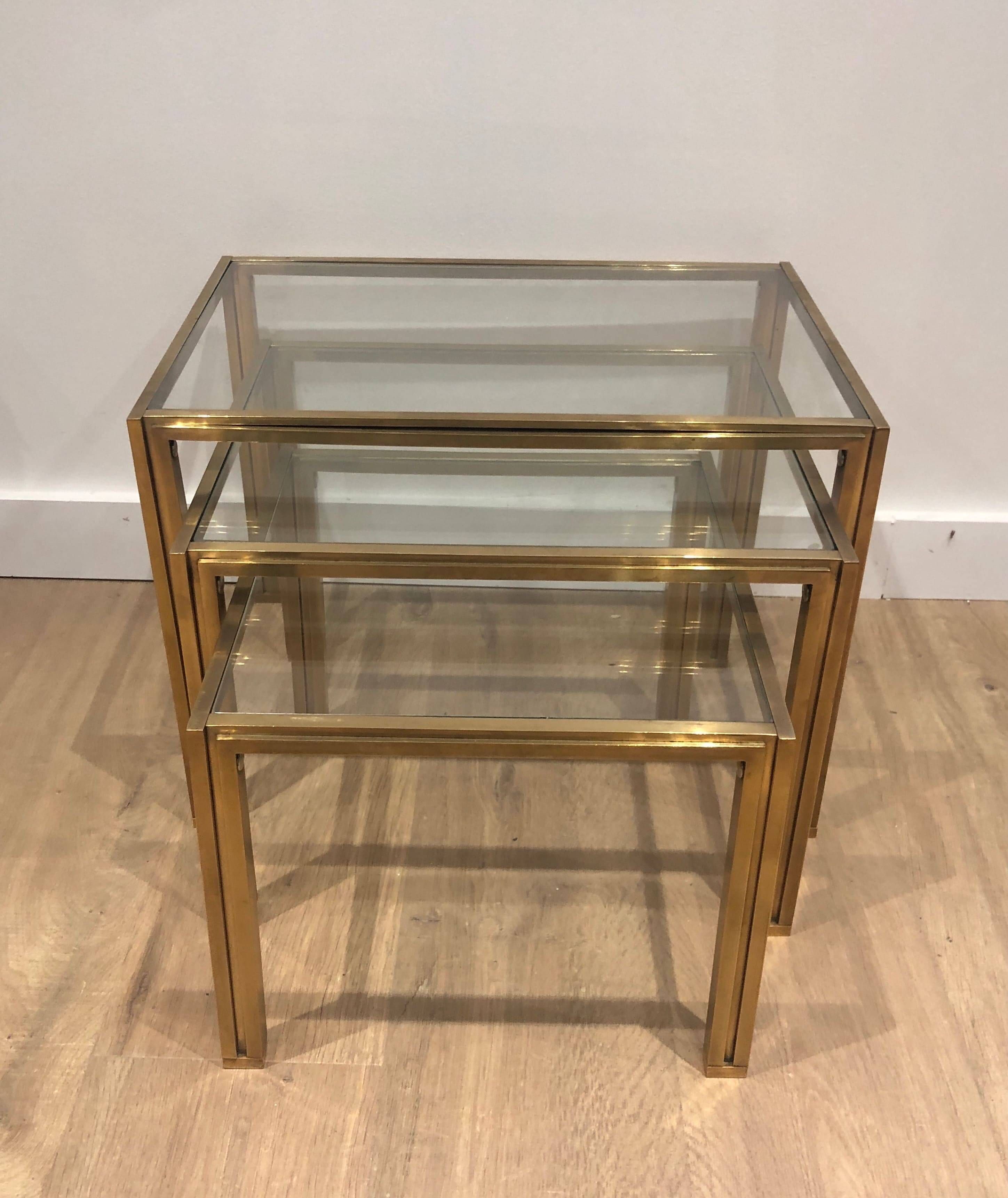 Set of 3 nesting tables in brass and glass. French work by Guy Lef.