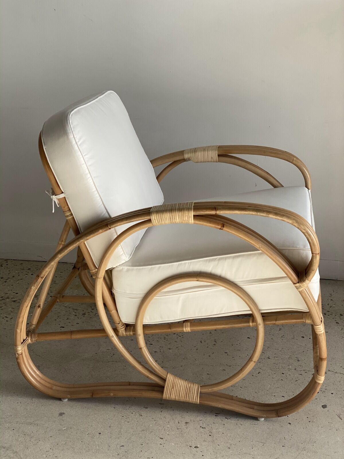Large rattan rest chair and white cushions