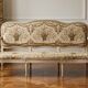 Louis XV style canapé in carved natural wood and floral upholstery.