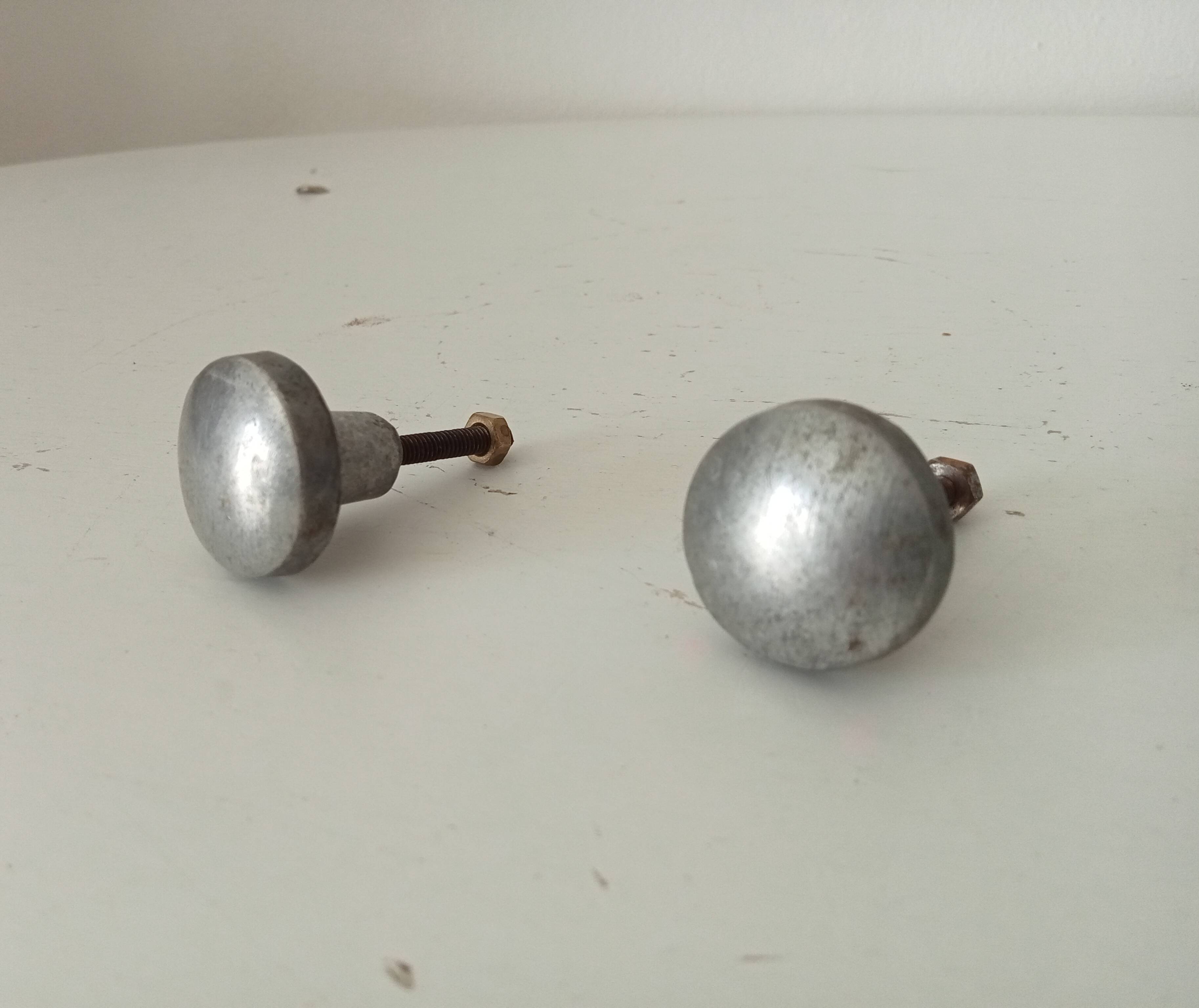 Pair of antique solid aluminium furniture handles.