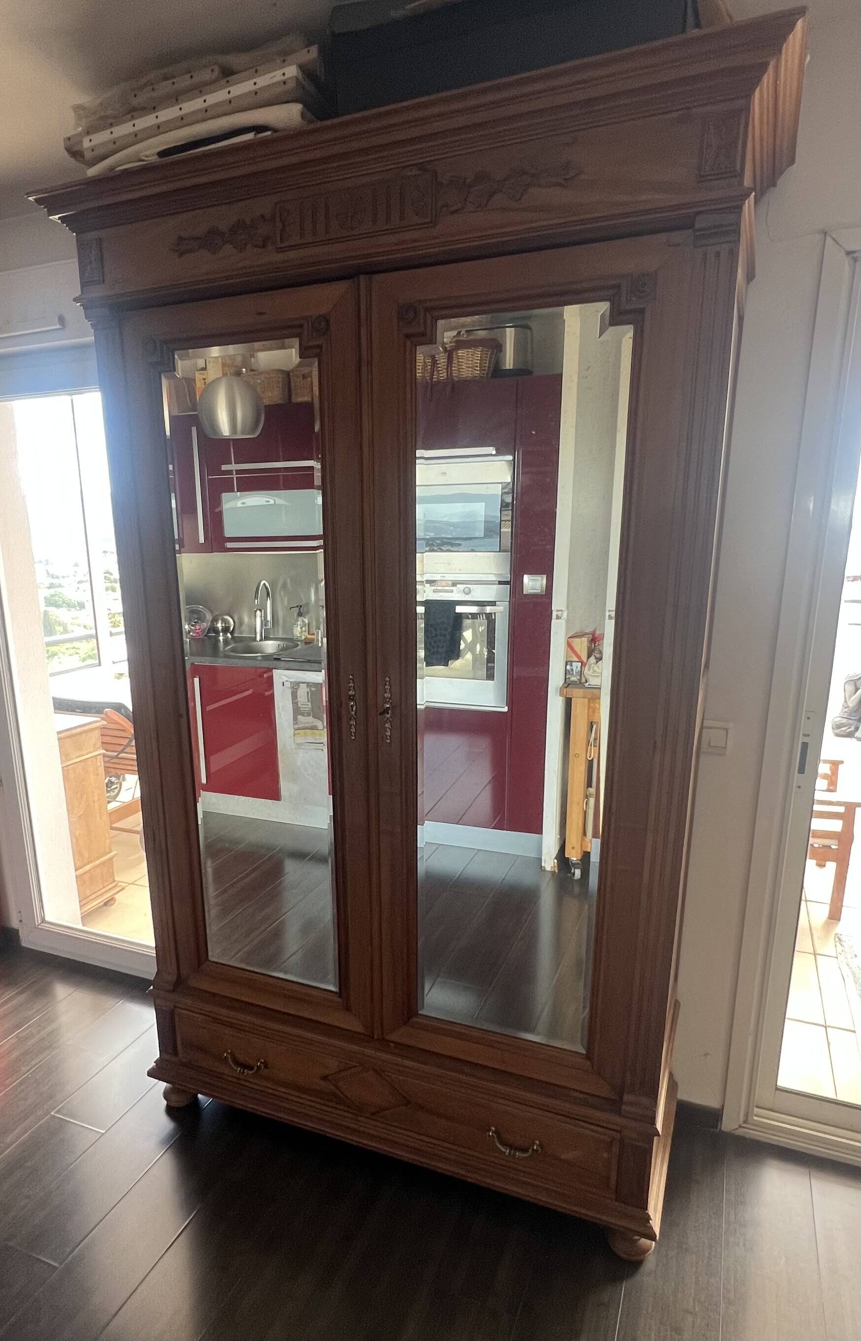Walnut wardrobe with mirror doors.