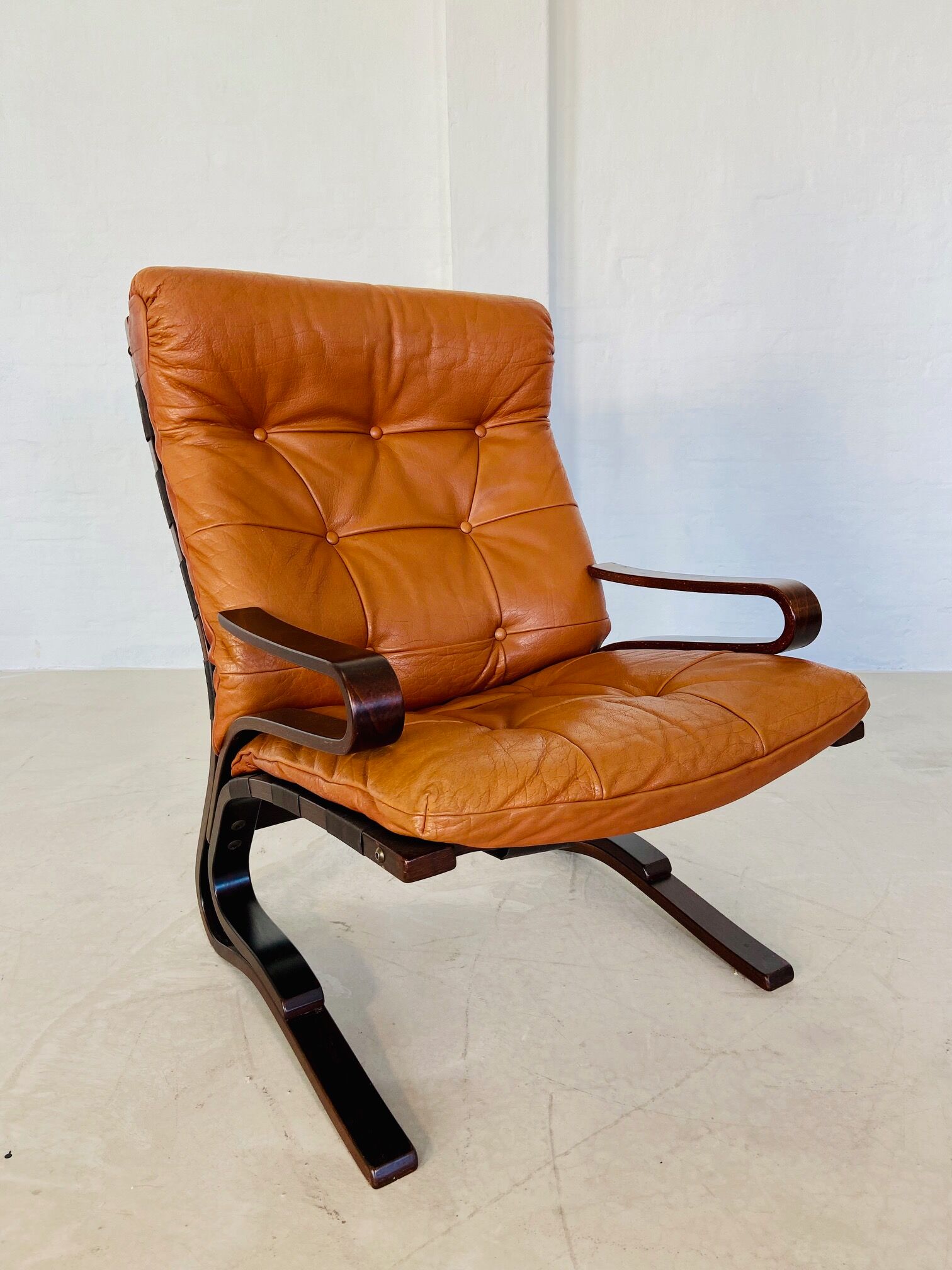 Vintage Scandinavian cognac lounge chair by Oddvin Rykken