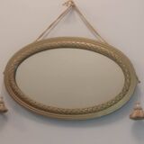Oval mirror in wood and gilded plaster with pompom decoration