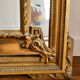 Large Napoleon III mirror 130 × 93 cm — gilded frame sculpted with ribbon pediment.