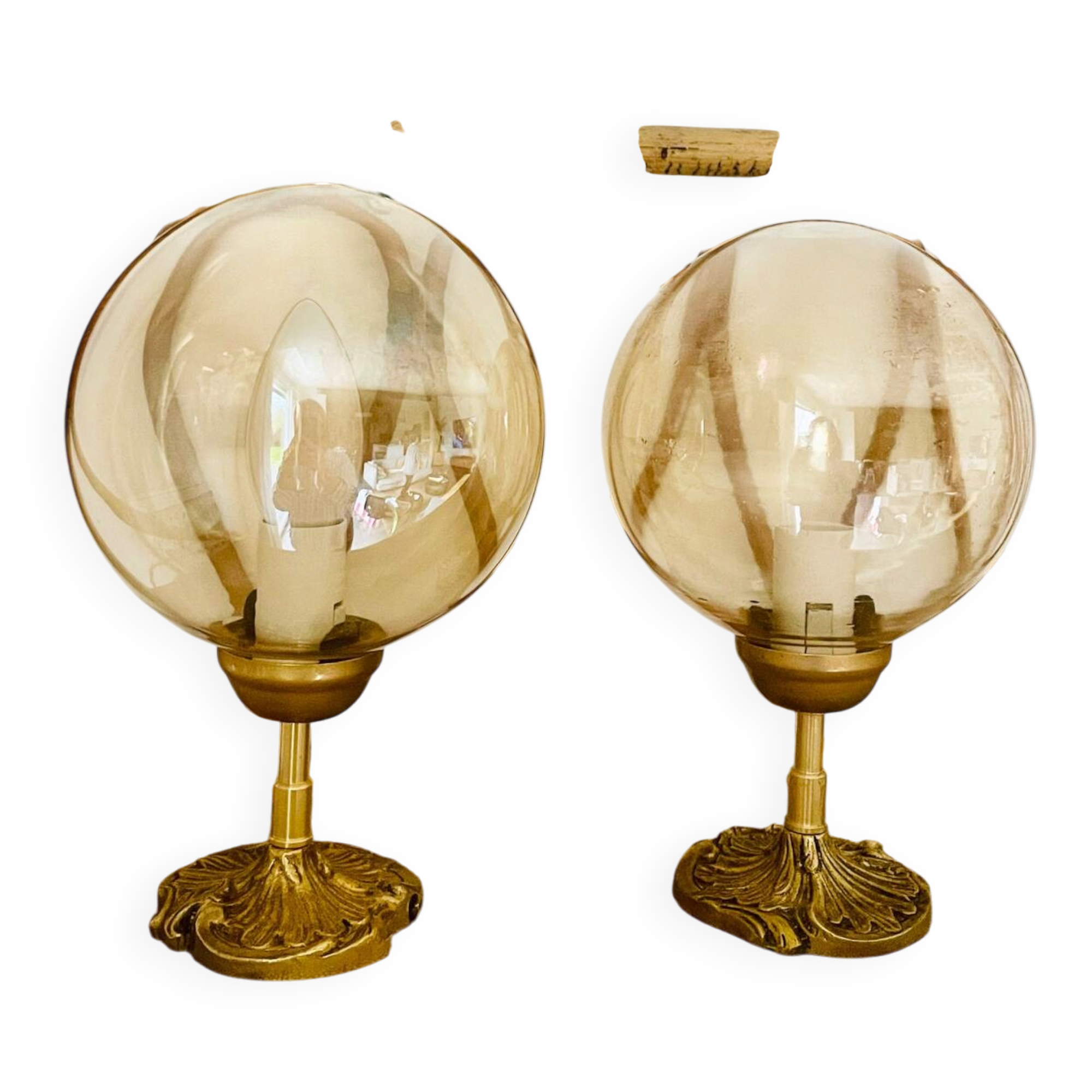 2 bedside lamps with round amber glass globes and gold metal.