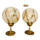 2 bedside lamps with round amber glass globes and gold metal.