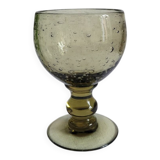 Footed glass made of blown glass