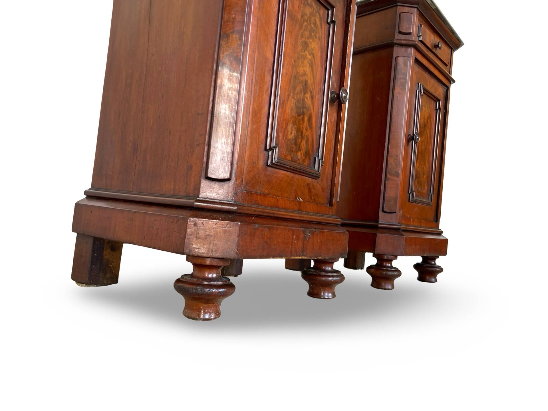 A pair of antique walnut bedside tables from the 1890s.
