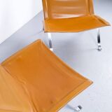 Imposante paire de fauteuils cuir et acier années 60'