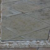 Chic and stylish antique mirror with carved wooden frame in whitewashed