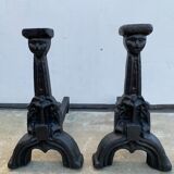 Pair of cast iron chenets with stylized faces High Epoch SEVENTEENTH century