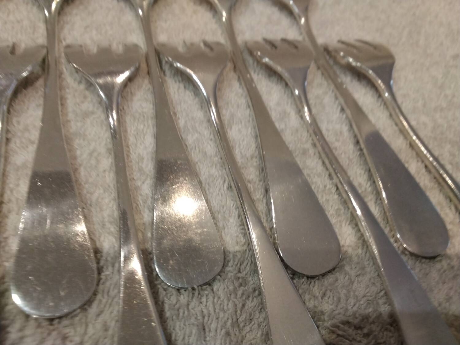 12 silver-plated oyster forks by silversmith J Brille with stick handles.