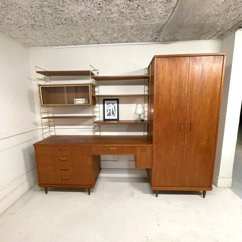 A piece of furniture combining a desk, wardrobe, and shelves.