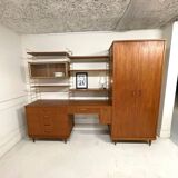 A piece of furniture combining a desk, wardrobe, and shelves.