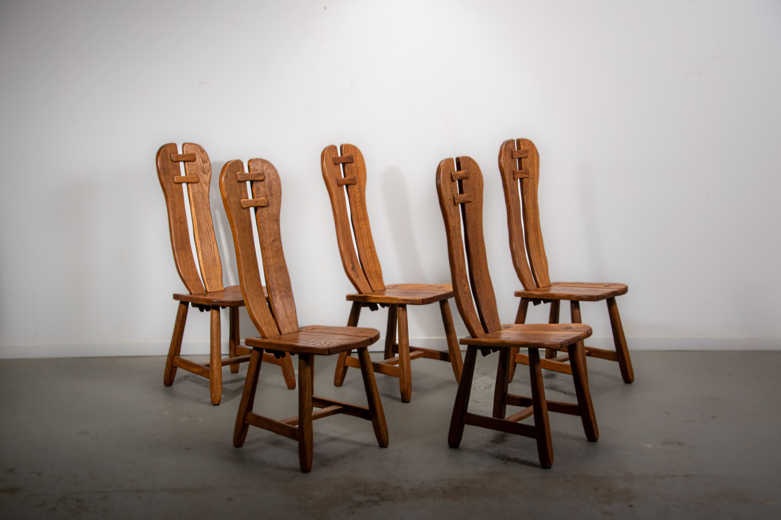 De Puydt brutalist dining chairs in solid oak. Circa 1970.