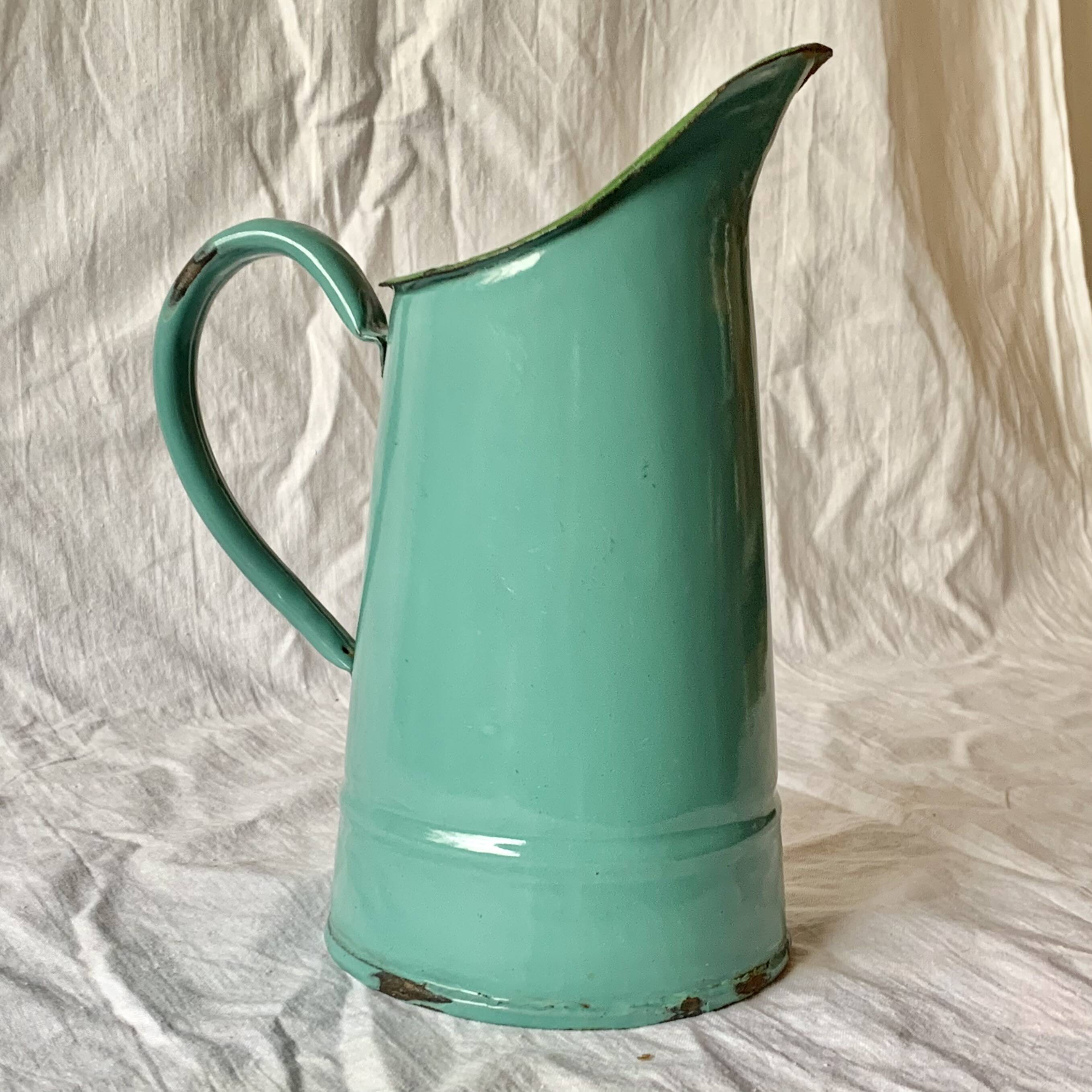Vintage pitcher in green enameled sheet metal