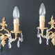 Pair of gilt bronze wall sconces with crystal pendants.