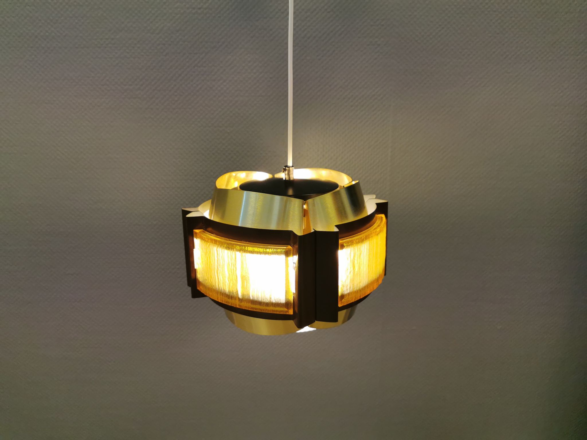 Danish hanging lamp, made in brass colored and brown metal, with yellowish hard pressed plastic deta