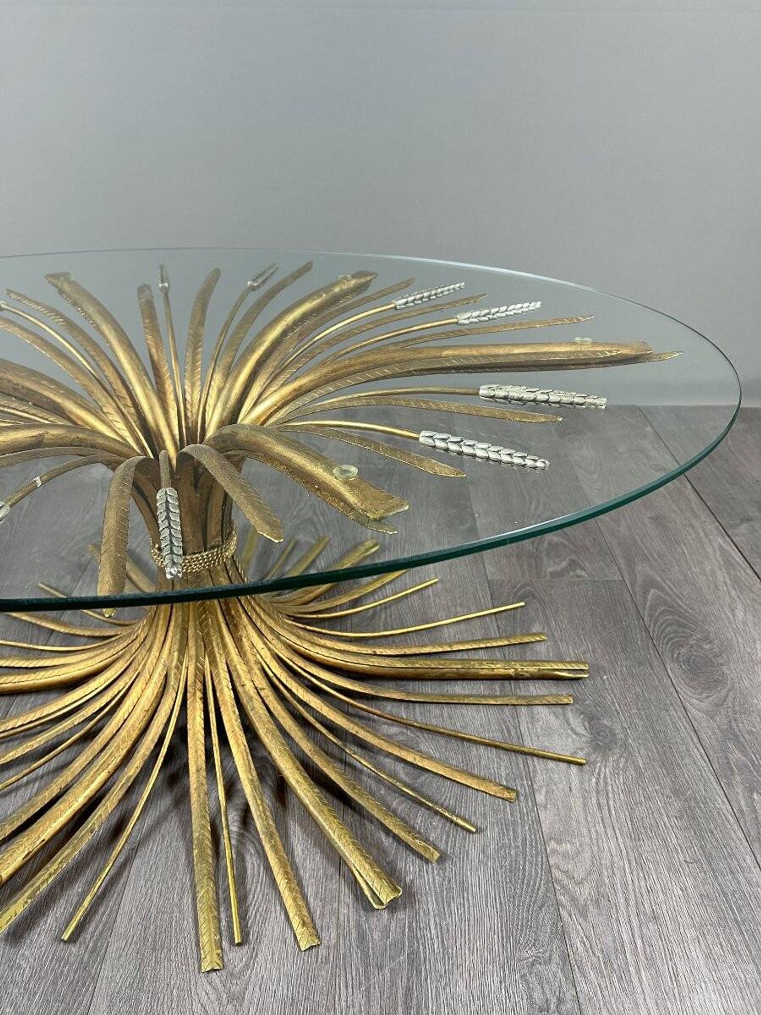 Gold metal and glass coffee table, 20th century, in the style of Robert Goos.