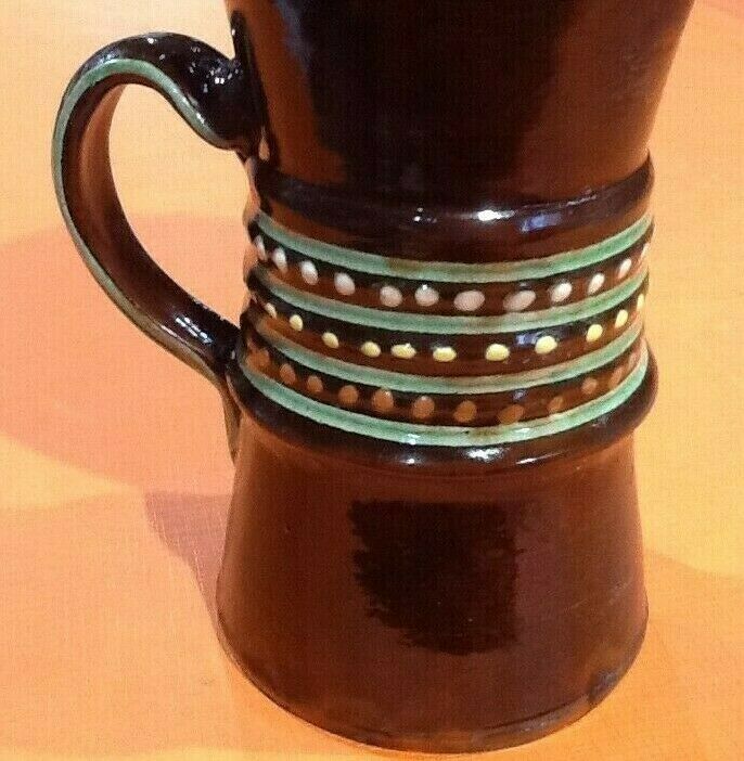 Glazed terracotta pitcher decorated with beaded friezes