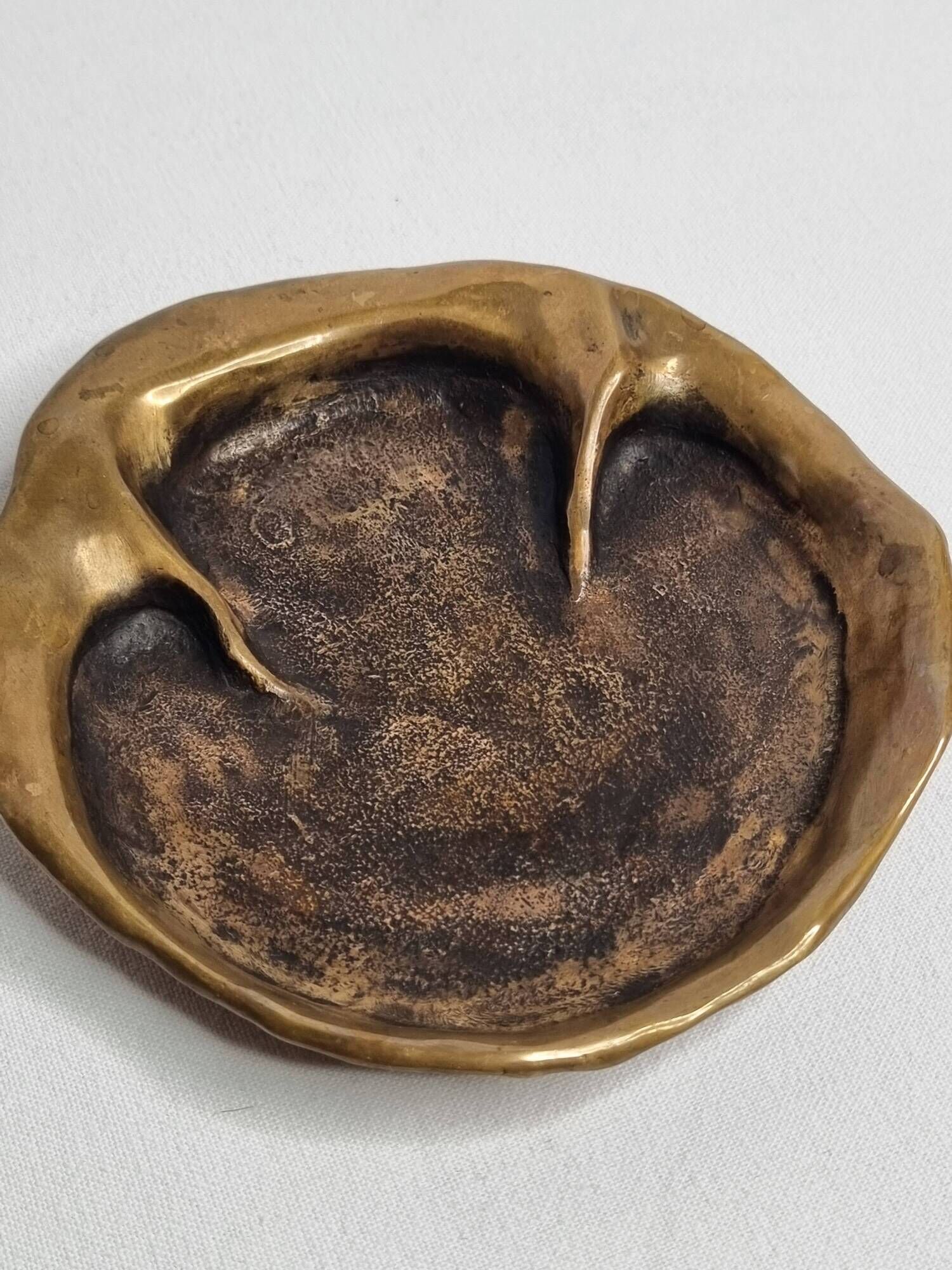 Bronze pocket emptier by Denis Mathews (1913-1997), "Rhinoceros Footprint" (12 cm), 1995