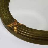 Faceted wall mirror in neoclassical Gustavian style, oval, in gilded wood, Italy, 1900s.