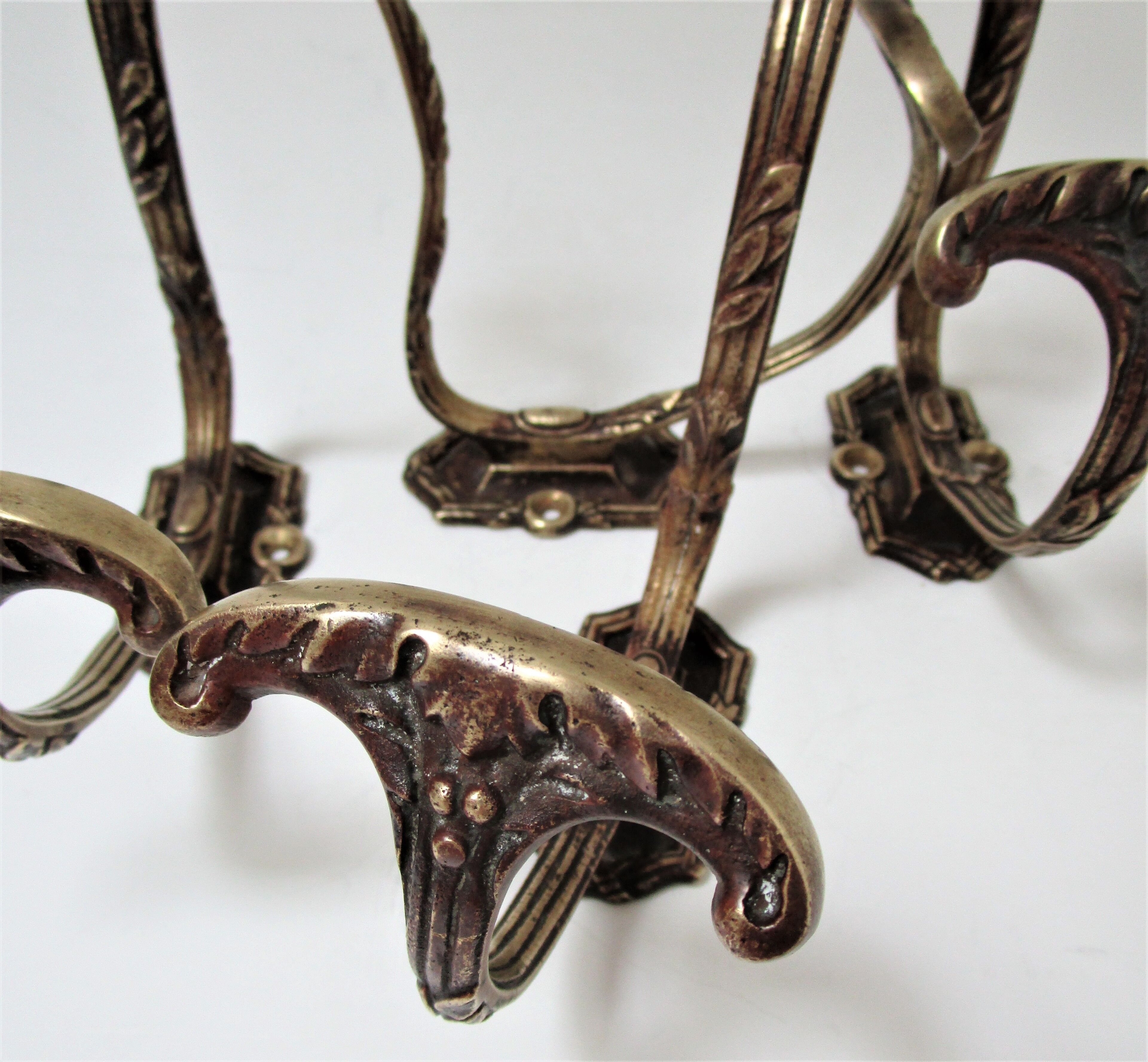 Four patères bronze patinated leafy décor early 20th century