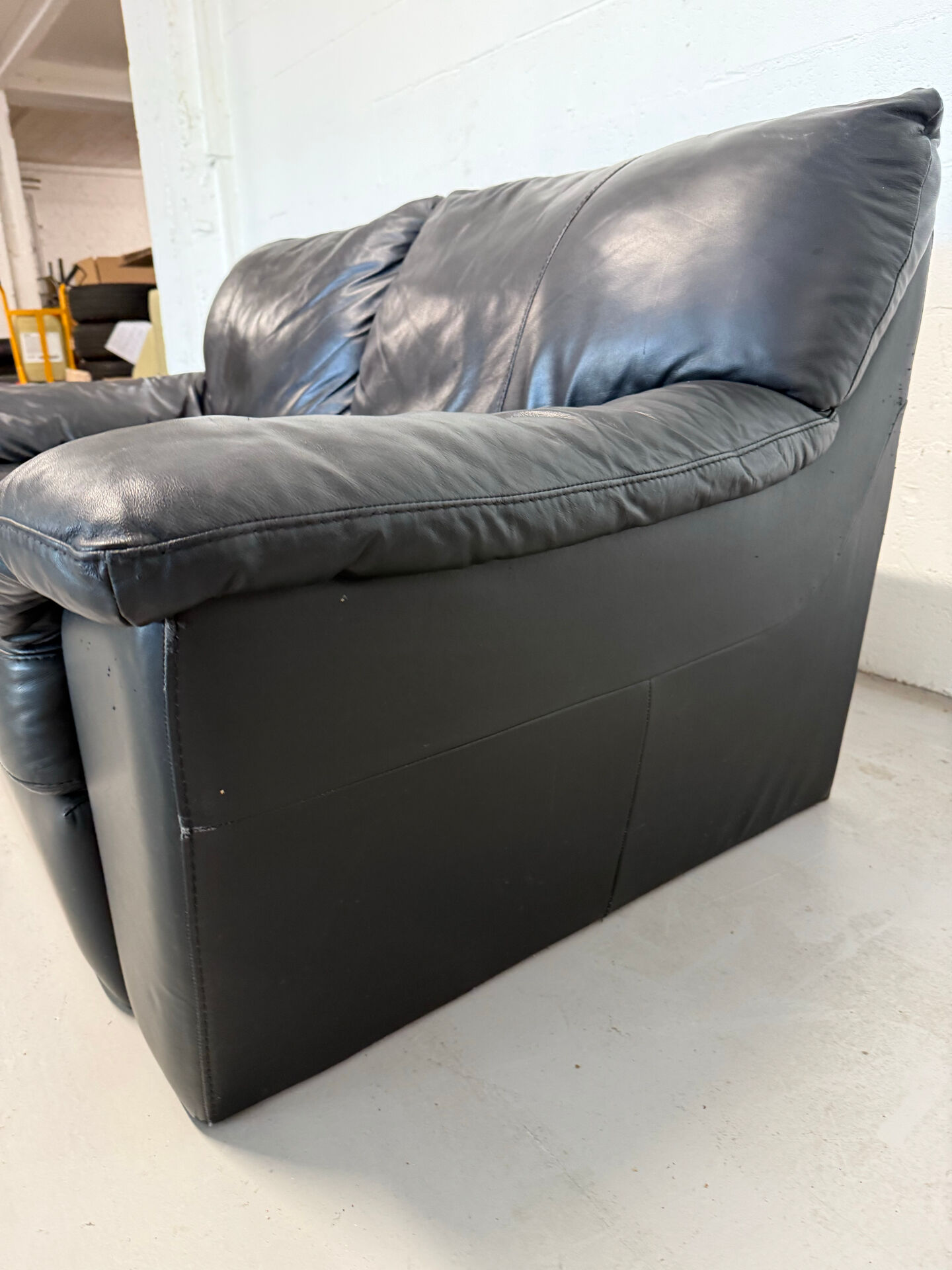 Two-seater black leather sofa — postmodern design