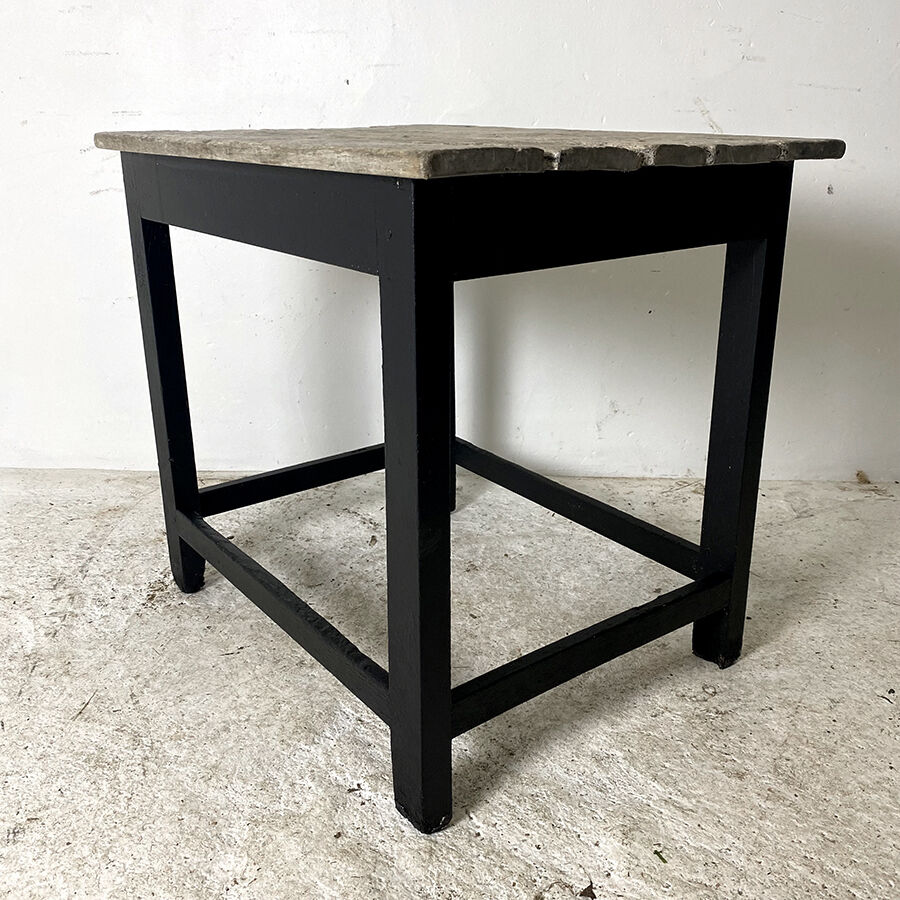 Old blackened wood work table and varnished top