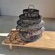 Braided rattan suspension in the shape of a black accordion