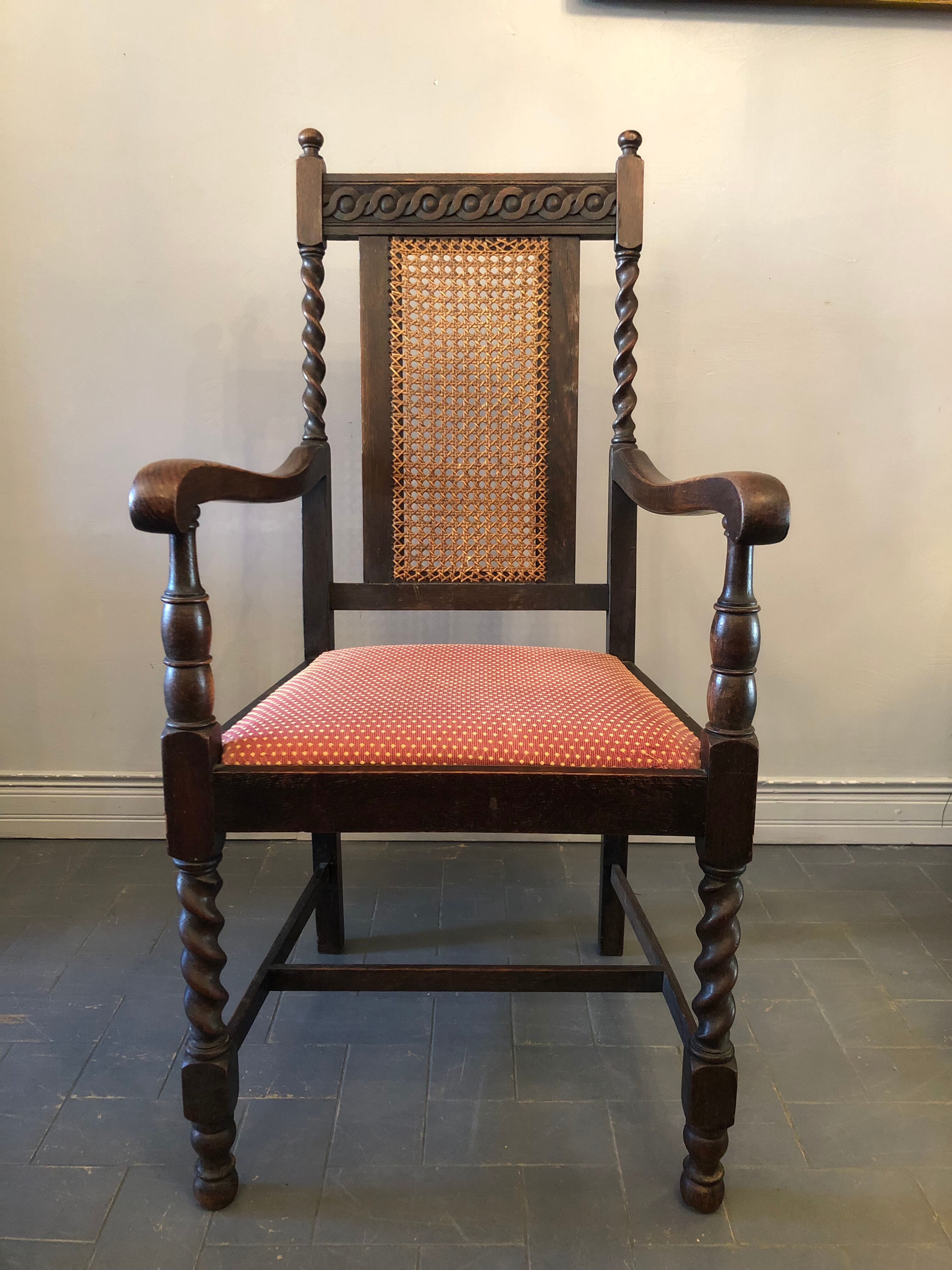 Carved wooden armchair and cannage