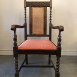 Carved wooden armchair and cannage
