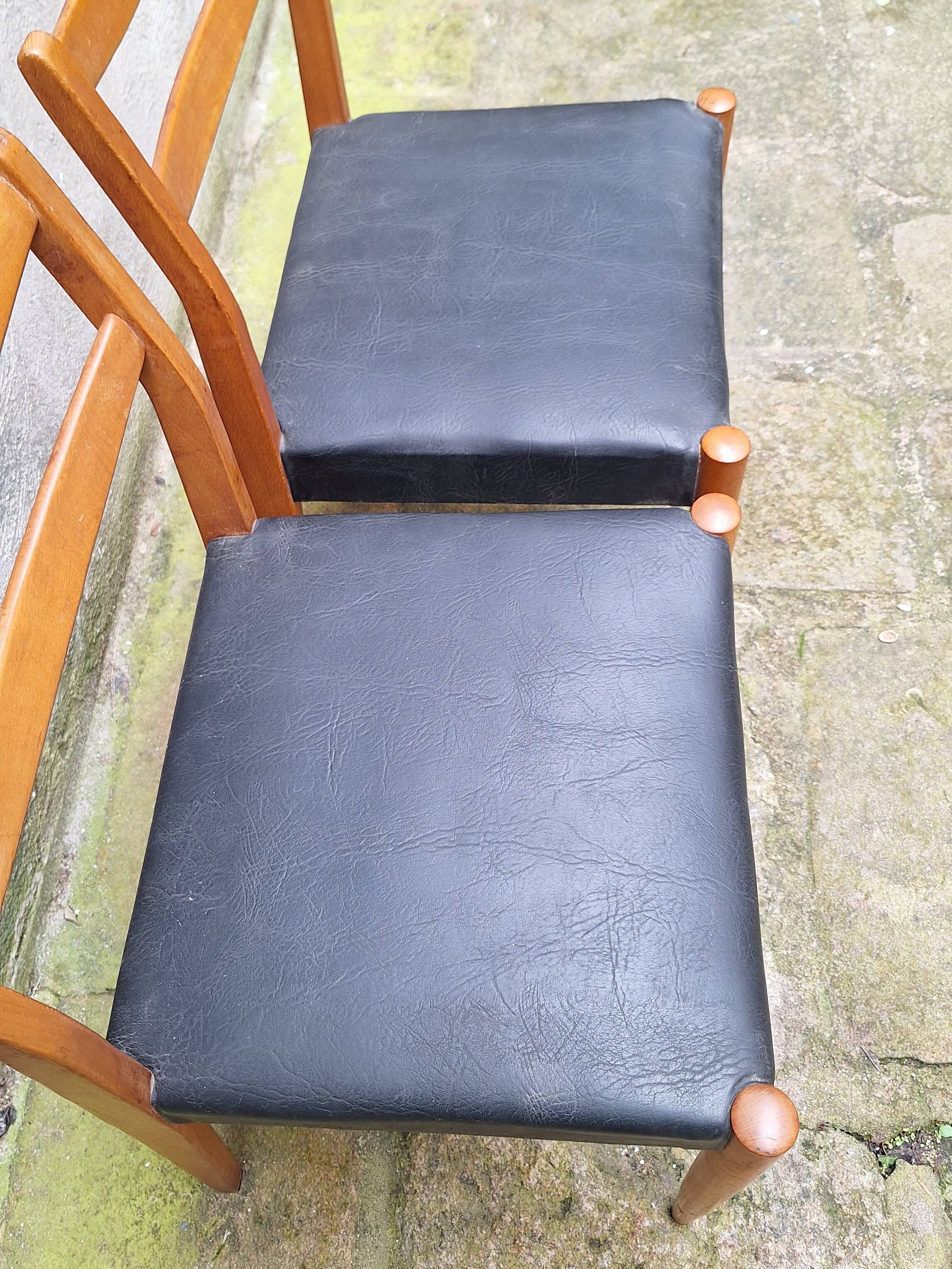 Pair of Scandinavian style chairs in wood and faux leather.