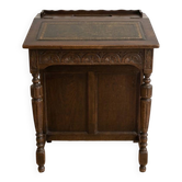 Antique wooden desk with a leather top.