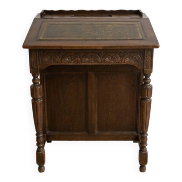 Antique wooden desk with a leather top.