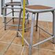 Set of four stackable industrial tubular metal and wood stools