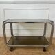 Rolling serving cart in chromed steel and smoked glass, 70s design